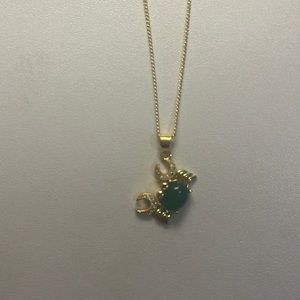 gold necklace with green crystal crab pendant with diamond accents